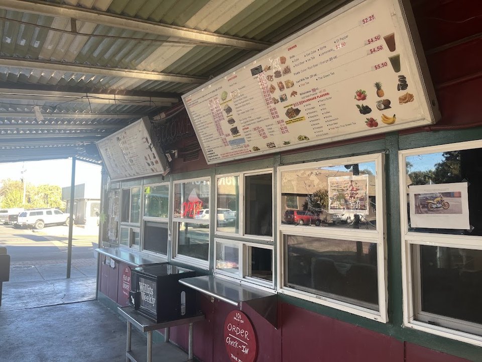 Menu board with burgers and fries.