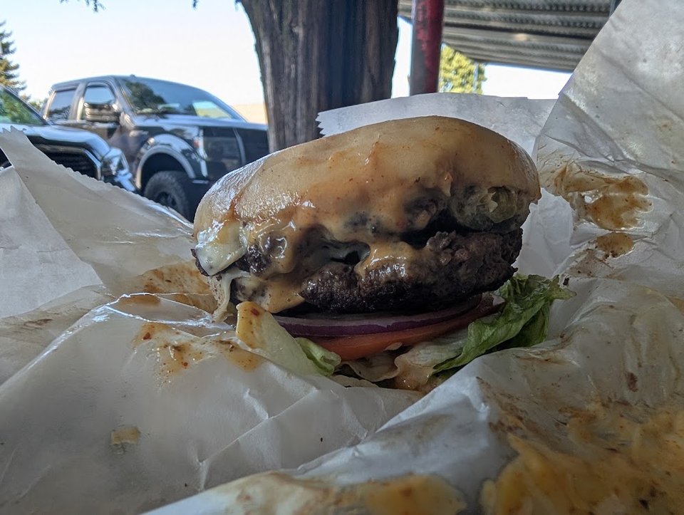Counter menu with hamburgers and onion rings.